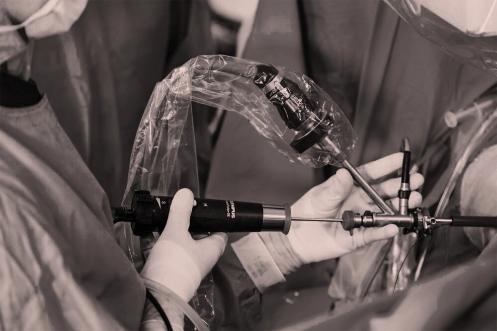 Surgeons performing minimally invasive endoscopic urology surgery using advanced medical instruments